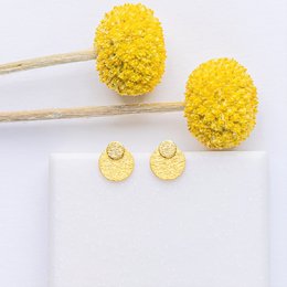 "Mix and Match PURE 04 stud earrings in yellow. Circular stud earrings with a textured, fuzzy surface. Comes in a white box with the brand name 'Zugevogel' printed on it."