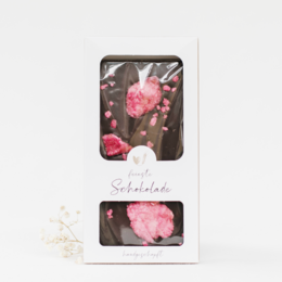 Dark chocolate gift box with pink rose-shaped chocolates. Delicate floral design, perfect for a romantic gift.