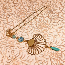 Retro bohemian-style headband with floral and pearl accents in violet, ivory, green, and brown color variants.