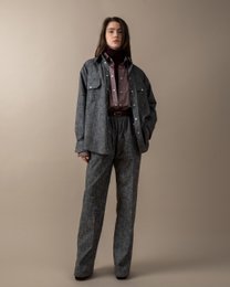  Relaxed, dark-colored trousers with a belted waist for women.