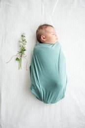 Soft, mint-colored swaddle blanket for newborn baby. Cozy and comfortable for snuggling.