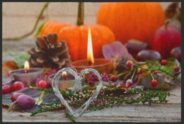 Autumn-themed doormat candle with pumpkins, pine cones, and berries. Candle flame, heart-shaped decoration, and various sizes and border options available.