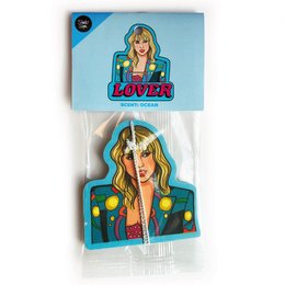 Taylor air freshener, a colorful and stylish diffuser with a retro-inspired design featuring a smiling woman with blonde hair and a polka dot jacket.
