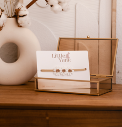  A bronze-colored hairband with a floral design, suitable for children.