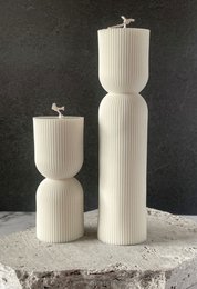 Tall, cylindrical pillar candles in a white, ribbed design. Available in large and small sizes.