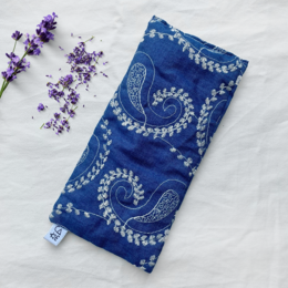 Lavender-filled eye pillow with a blue paisley pattern design. The pillow is made of soft, comfortable fabric and is filled with soothing lavender to help promote relaxation and sleep.