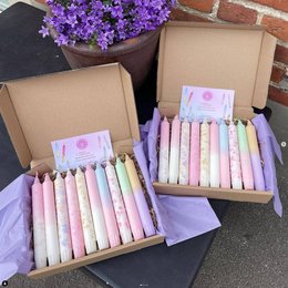 Pastel-colored taper candles in a box, perfect for dinner settings. Includes a variety of soft, muted shades like lavender, pink, and mint.