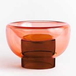 Large orange glass bowl with a simple, modern design. Suitable for decorative display or serving purposes.