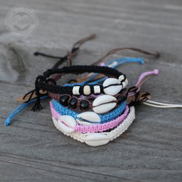  Handmade bracelets from Bali featuring colorful beads, shells, and braided threads in pink, white, brown, and black. Suitable for kids.