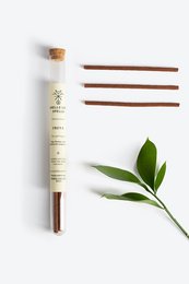 Natural incense sticks with a green leaf, earthy and aromatic.