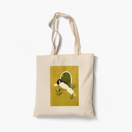 Organic tote bag with a bold, graphic design featuring a heart-shaped leaf in shades of green and yellow on a mustard yellow background.