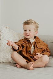 Oversized corduroy jacket in rust color, available in sizes 1 year to 6 years, featuring a button-up design and a cozy, textured fabric.