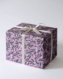 Small mistletoe-patterned wrapping paper in shades of purple and green.