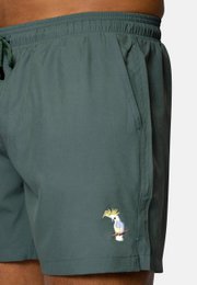  Green swim shorts with cockatoo graphic, available in sizes S-XXL.
