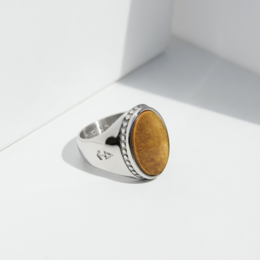 Silver ring with tiger eye gemstone, available in various sizes. Signet-style ring with a round, oval-shaped tiger eye stone set in a silver band.