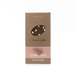 Dark chocolate bar with Cirmolo pine nuts. Rectangular shape, brown packaging with a logo. Contains information about the ingredients and origin.