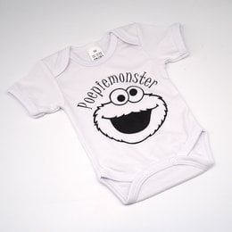 A white baby romper with a black and white graphic of the Cookie Monster character from Sesame Street. The text "Nom nom nom nom" is printed below the character's face.