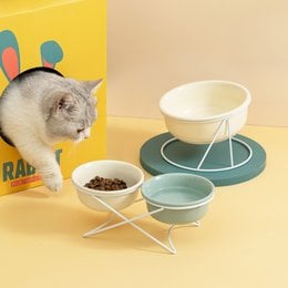 Ceramic pet bowls with stand in various colors and sizes for cats and dogs. The bowls feature a modern, minimalist design with a sturdy metal stand.