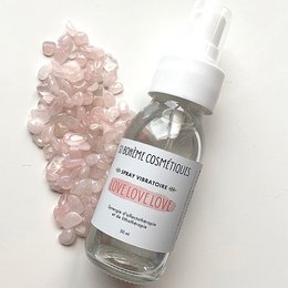 A vibrant, love-inspired room spray with a blend of floral and citrus notes, packaged in a clear glass bottle.