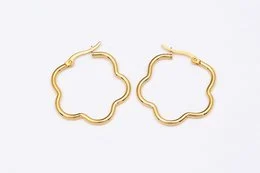 Gold-tone stainless steel hoop earrings with a floral design.