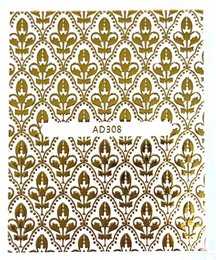 Gold patterned nail stickers in various designs, including floral and abstract motifs, suitable for manicure and nail art.