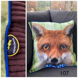  Decorative cushion cover featuring a close-up image of a fox's face. The cushion has a soft, plush texture and vibrant colors that would complement a variety of home decor styles.