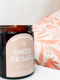 Festive scented candle with "Cookies for Santa" label, round shape, dark brown color, and cozy holiday vibes.