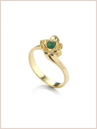  Burnished gold and silver stack rings with emerald, sapphire, and ruby accents. Elegant and stylish jewelry for everyday wear.