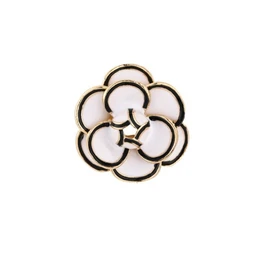 White brooch with circular flower design, brown metallic outline, elegant botanical style accessory