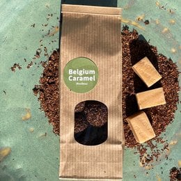 Caramel-flavored tea crystals in a brown paper bag, with pieces of caramel visible.