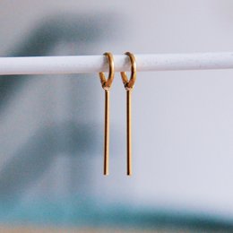  Large gold hoop earrings with a bar detail, made of stainless steel for a durable and stylish accessory.