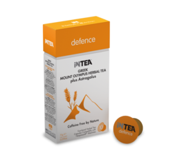 Functional tea with Mt. Olympus herbs, 10 capsules. Orange tea capsule box and tea leaves on wooden surface.