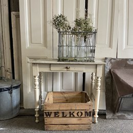 Wooden storage box/crate with "Welcome" text, featuring a rustic, farmhouse-style design with a wooden frame and slats. The box is used for storage and decor, suitable for an entryway or living room.