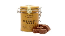 A round, tall metal tin containing Belgian chocolate fudge pieces. The tin has a gold and white label with the text "Cartwright & Butler - Belgian Chocolate Fudge in Can".