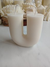  White, textured, house-shaped pillar candle with a cozy, festive appearance.