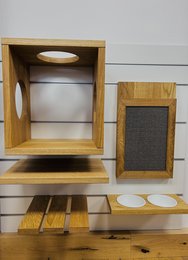 Wooden pet toy starter pack with various compartments and shelves for storage and display. Includes natural wood tones and textures.