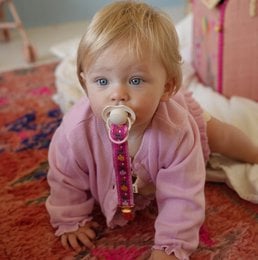 Pink pacifier clip with floral pattern, fabric strap, baby accessory