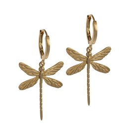 Gold dragonfly hoop earrings with intricate wing details.