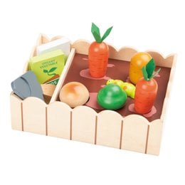 Wooden toy vegetable garden set with various colorful wooden vegetables and gardening tools.