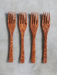 Coconut forks, set of 4 wooden forks with natural grain and texture, suitable for table settings or serving.