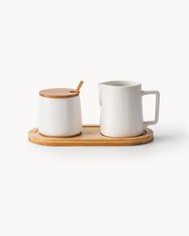  White and black ceramic sugar and creamer set with wooden tray and spoon.