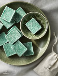 Patchouli-scented amber-colored wax blocks in a square shape, with a textured surface.