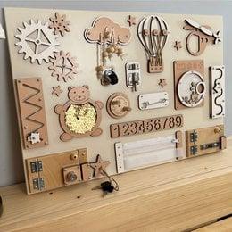 Blue busy board with various shapes, textures, and interactive elements for sensory play and development.