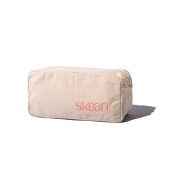 Beige canvas toiletry bag with red "Skean" text logo. Rectangular shape, simple and minimalist design.