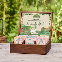A wooden display tea box containing a set of tea bags labeled "Saatgeschwister set 'Allstars'". The box has a green and white design with illustrations of plants.