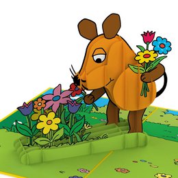 Floral greeting card with a pop-up mouse holding a bouquet of colorful flowers against a grassy background.