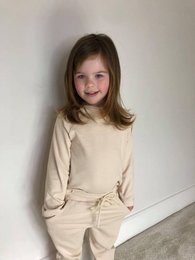 Oatmeal colored loungewear for kids, available in sizes 6-9 months, 9-12 months, 2-3 years, 3-4 years, and 4-5 years.