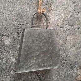Hammered metal pendant with a round handle, suitable for hanging or displaying.