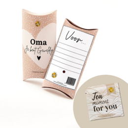 A gift box for Grandma featuring a pink and gold design with the text "Oma" and "Oma's favorite things". The box contains a card with the text "Voila..." suggesting it may contain a special gift for Grandma.