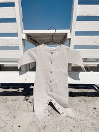 Soft, cozy white baby romper with snap closure, perfect for newborns and infants up to 12 months. Made of comfortable, breathable cotton material.